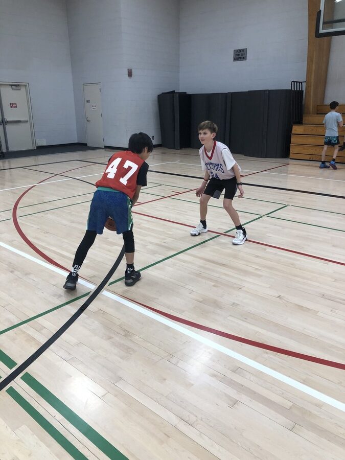 boy guarding another boy for East Bay Bulldogs Basketball 